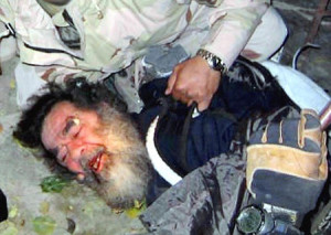 former Iraqi leader Saddam Hussein moments after his capture by US forces in a farm house outside Tikrit